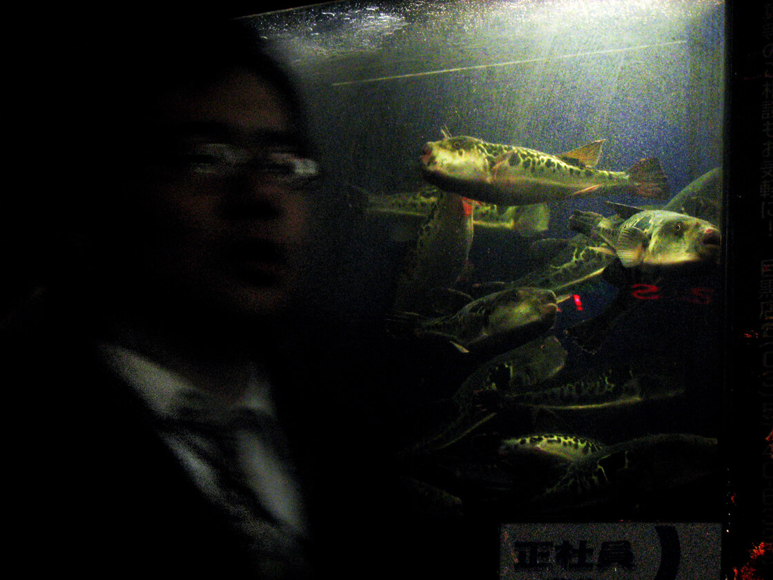 a salaryman in front of a Fugu (pufferfish) restaurant in Meguro
